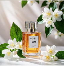 Load image into Gallery viewer, Hayat A premium floral Oudh unisex perfume — 50ml clear glass bottle with gold accents. Lily,  jasmine, gardenia , sandalwood &amp; musk fragrance — EsQue Parfum — styled with fresh white jasmine flowers &amp; green leaves
