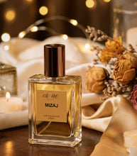 Load image into Gallery viewer, Mizaj. A premium floral spicy unisex Oud perfune — 50ml gold glass bottle ambed, saffron, sandalwood &amp; rose fragrance. EsQue Parfum — styled with soft satin fabric, candles &amp; dried florals - handmade in UK 