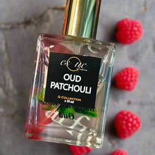 Load image into Gallery viewer, Oud Patchouli — rich earthy unisex perfume — 30ml clear glass bottle with gold cap — deep oud, earthy patchouli, raspberry &amp; Bulgarian rose  fragrance — EsQue Parfum — styled with fresh raspberries on textured stone surface