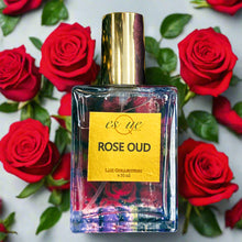 Load image into Gallery viewer, Rose Oud — rich floral‑woody unisex perfume — 30ml clear glass bottle with gold cap — velvety rose, precious oud, warm amber &amp; soft musk fragrance — EsQue Parfum — surrounded by fresh red roses and green leaves - Dubai in a bottle 